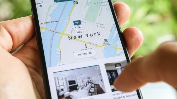 An cell phone showing the Airbnb app.