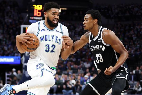 Karl Anthony-Towns, who scored a game-high 28 points, looks to drive around Nic Claxton during the Nets' 101-86 loss to the Timberwolves.