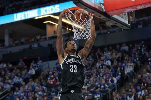 Nick Claxton slams home a dunk during the Nets' loss.