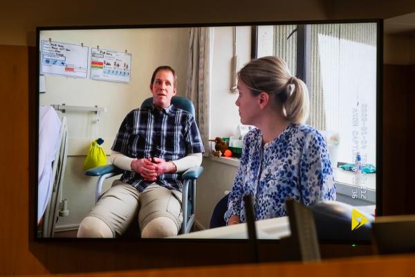 The video interview of US citizen Matthew Urey, left, is played to the court on a screen at the Whakaari White Island eruption trial.