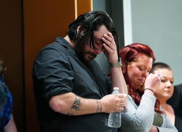 Devon Vestal, front, and his wife, Jess, react as they listen during a news co<em></em>nference to announce plans to sue the Littleton, Colo., school district for abuse suffered by their autistic child while riding the bus to class Tuesday, April 9, 2024, in Denver.