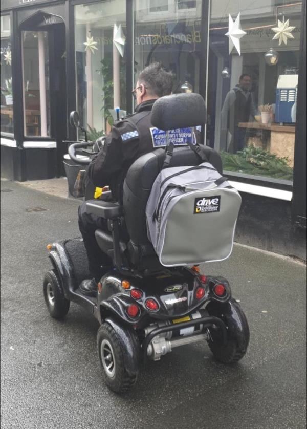 Police officer riding the scooter.