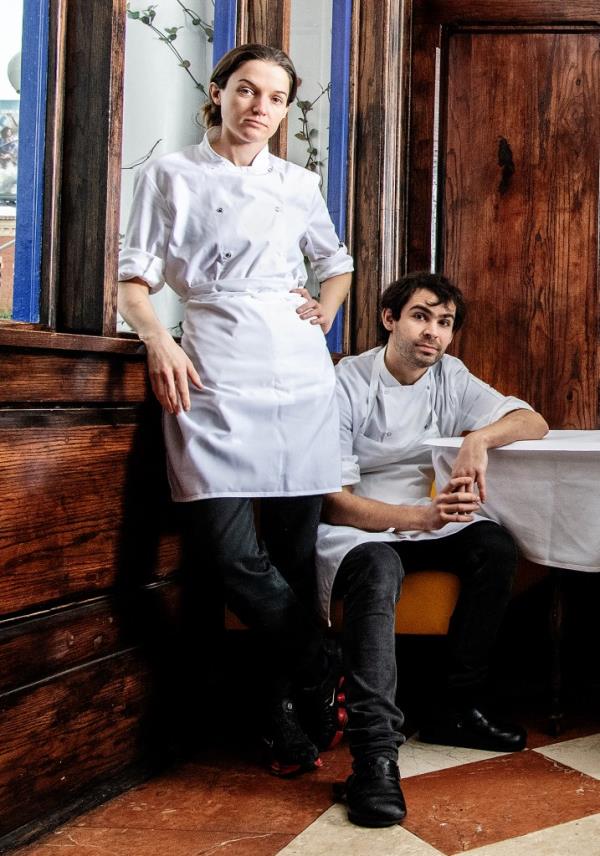 Liz Johnson, standing, and Will Aghajanian, sitting, in the dining room at Horses.