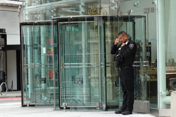 A security guard stands outside the San Francisco Centre Mall, which was operated by Westfield before it backed out.