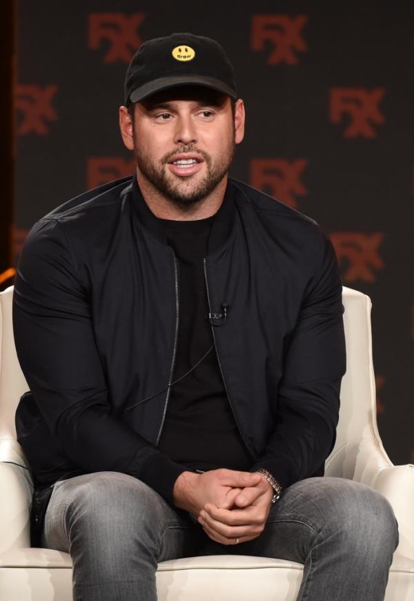 Scooter Braun sitting on a couch.