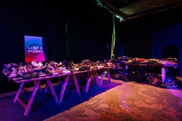 The lost and found with a table of shoes and another with bags.