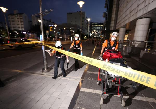 Rescue workers are seen at a scene wher<em></em>e, according to media reports, nine people have been stabbed and four others hurt by a car driven by the suspected attacker in Seongnam, South Korea.