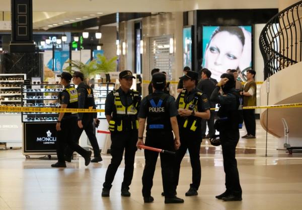Police officers cordon off the scene near a subway station in Seongnam, South Korea.