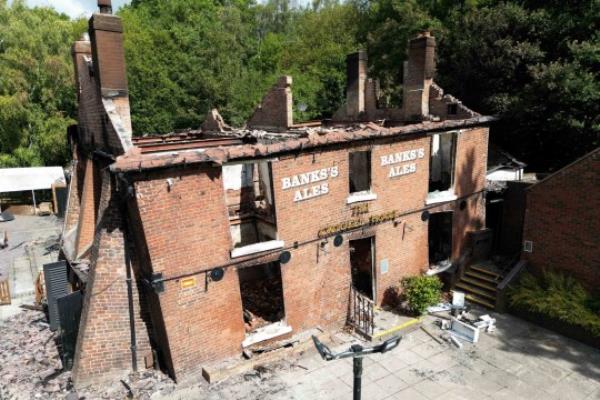 The burnt out remains of The Crooked House pub near Dudley. A fire gutted the 18th century pub just days after it was sold to a private buyer. Firefighters and police were called to the pub in Himley, West Midlands, at 10.45pm on Saturday. The blaze was extinguished and no-one was reported to have been injured, Staffordshire Police said. Picture date: Mo<em></em>nday August 7, 2023. PA Photo. See PA story FIRE Crooked. Photo credit should read: Jacob King/PA Wire