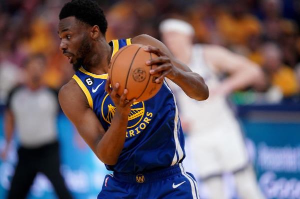 Golden State Warriors forward Andrew Wiggins (22) holds o<em></em>nto a rebound against the Sacramento Kings in the first quarter during game six of the 2023 NBA playoffs at the Chase Center.