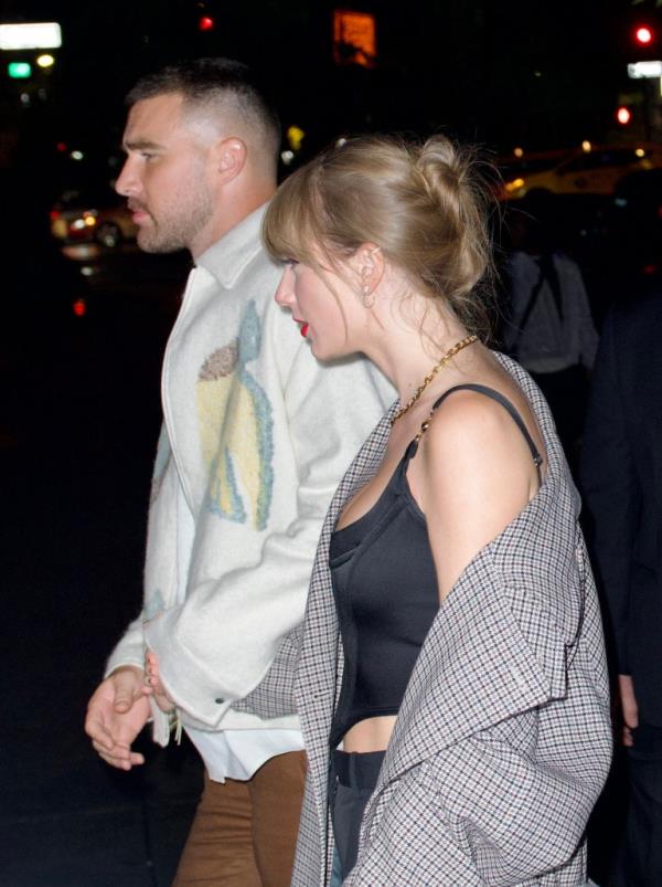 Travis and Taylor holding hands