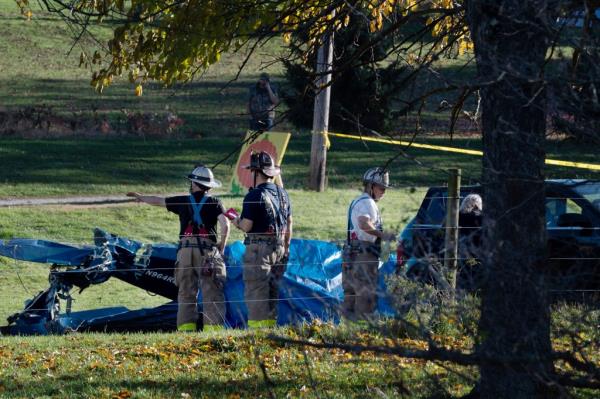 Firefighters investigate after a fatal small plane crash in a yard at Dorance Farm