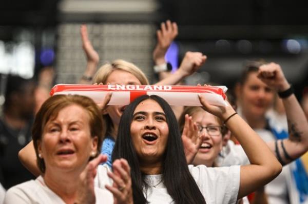 England fans celebrate their team first goal as they watch a screen showing the Women's World Cup semi-final football match between Australia and England, at Boxpark Wembley in Lo<em></em>ndon on August 16, 2023. (Photo by JUSTIN TALLIS / AFP) (Photo by JUSTIN TALLIS/AFP via Getty Images)