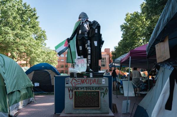 The statue of George Washington is covered by Palestinian flag at encampment of pro-Palestinian protestors in the George Washington University.