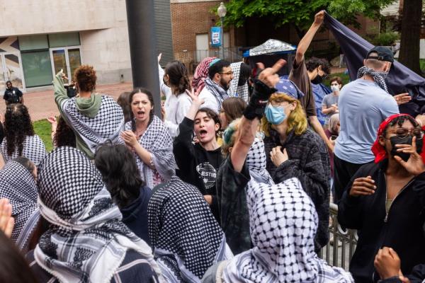 Pro-Palestinian protesters jeer at campus police (not pictured) after the police cut down a Palestinian flag in the o<em></em>ngoing student encampment.