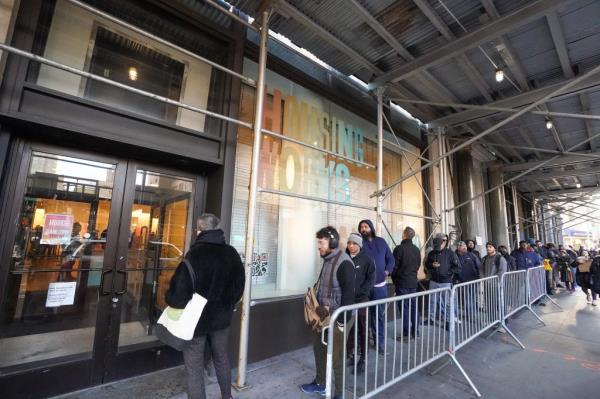 Overview of line of people waiting to enter, at Housing Works Cannabis Co., located at 750 Broadway.