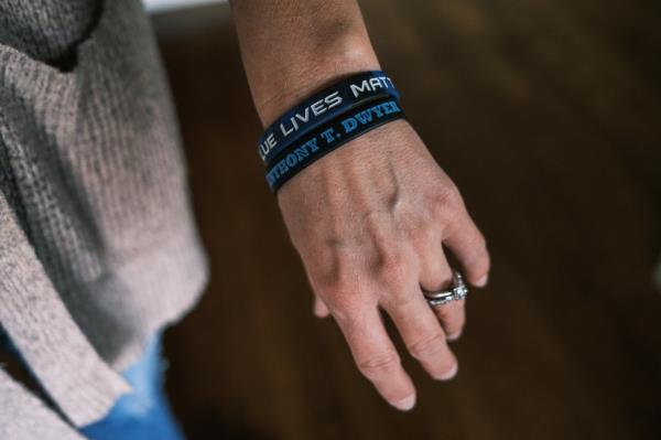 A loved one wears two wristbands that read, 