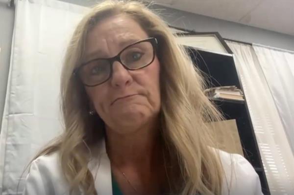 A woman with glasses making a face.