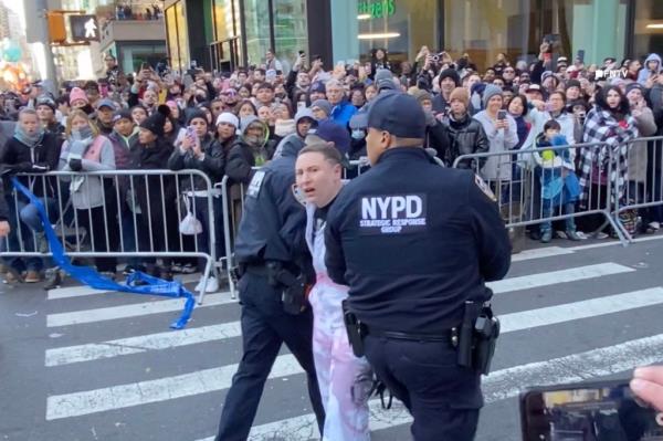 Protesters shut down Macy's Parade route by gluing themselves to the ground, demanding 