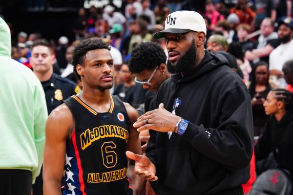  Bro<em></em>nny James #6 of the West team talks to Lebron James of the Los Angeles Lakers after the 2023 McDonald's High School Boys All-American Game