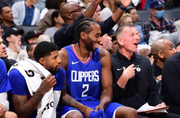 Kawhi Leo<em></em>nard (2) smiles on the Clippers bench next to Paul George (l.) during their win over the Trail Blazers on Oct. 25, 2023.