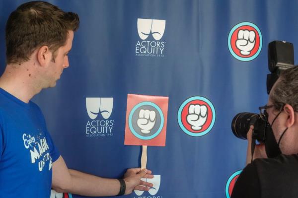 Workers next to logo of the Actor Equity Association