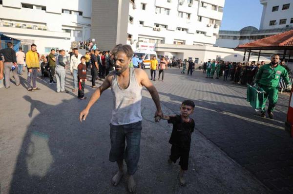 An injured Palestinian man and boy arrive to Al-Shifa hospital in Gaza City following Israeli bombardment on Sunday.