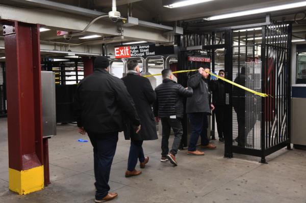 Police enter subway to investigate shooting.
