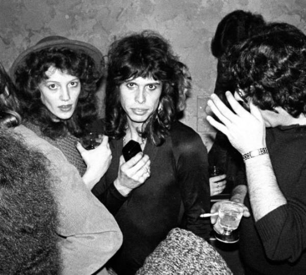 A black and white picture of Steven Tyler backstage at a gig.