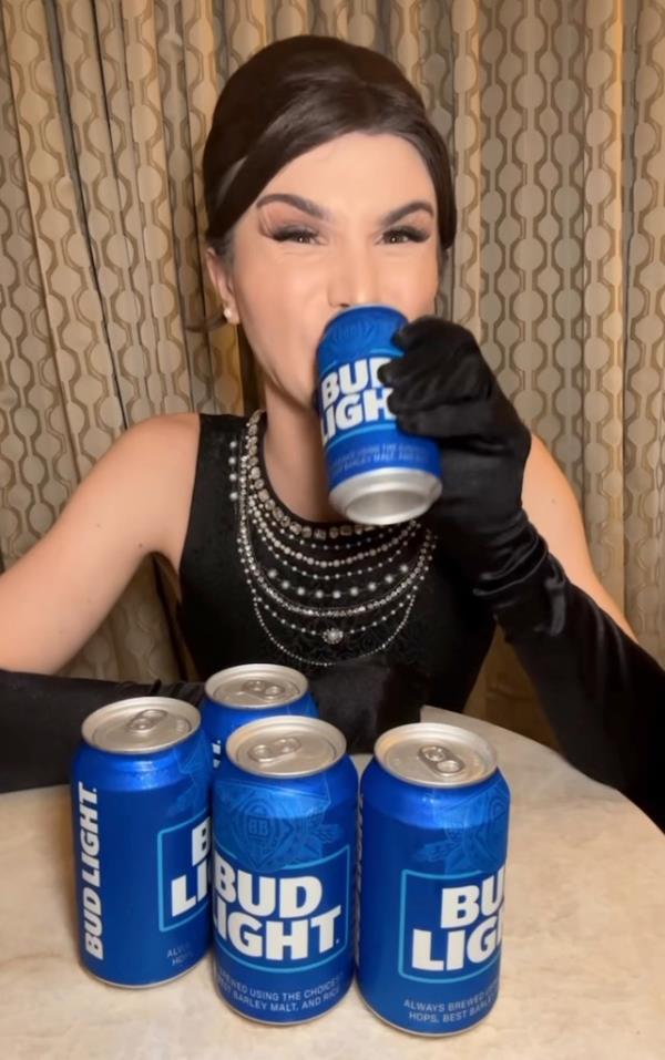 Dylan Mulvaney holding a Bud Light can