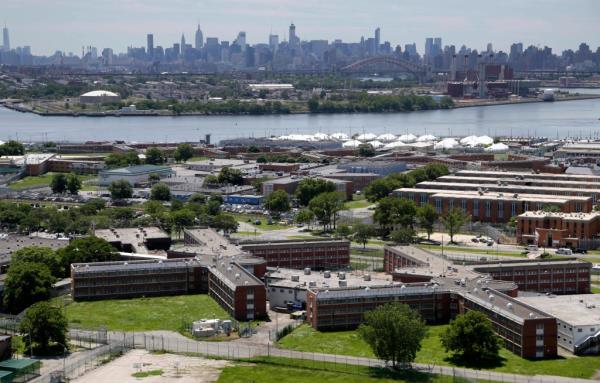 The Rikers Island jail complex stands with the Manhattan skyline in the background on June 20, 2014, in New York.