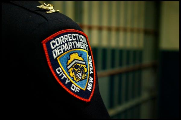 A Correction Department badge on an officer at the Vernon C. Bain Correctio<em></em>nal Center at Rikers Island, in the Bronx. 