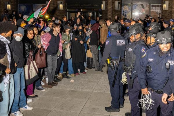 NYPD officers and protestors face off as law enforcement clear out anti-Israel protest encampment on the campus of NYU on April 22, 2024.