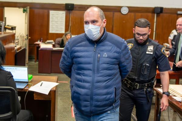 Alexander Shaporov is pictured being escorted out of a courtroom in Manhattan. 