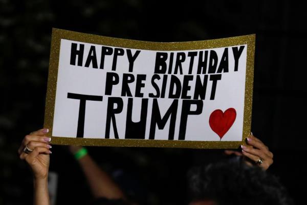 Supporters holds up sign saying 
