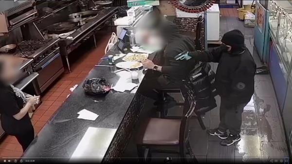 man points gun at worker
