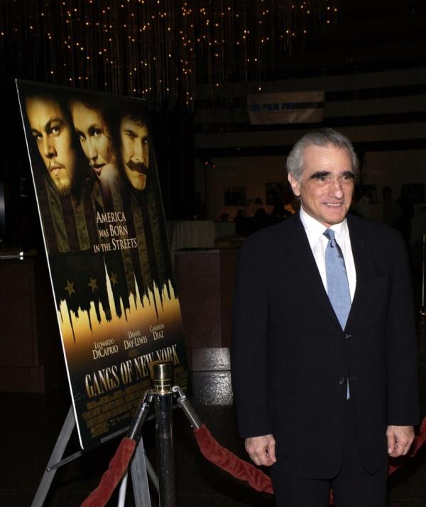 Photo of Martin Scorcese in front of a movie poster.