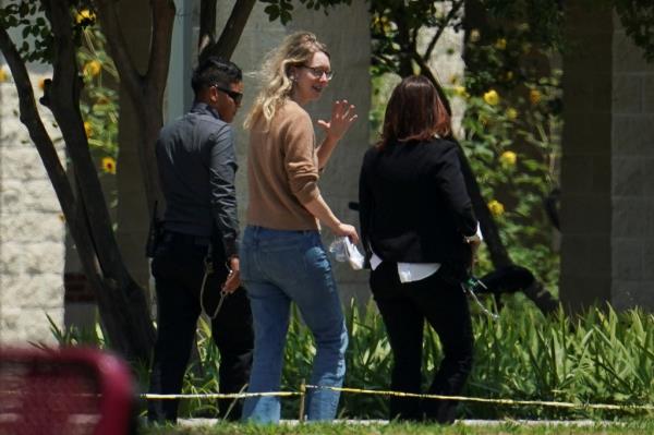 Disgraced Theranos CEO Elizabeth Holmes being escorted by prison officials into a federal women's prison camp in Bryan, Texas
