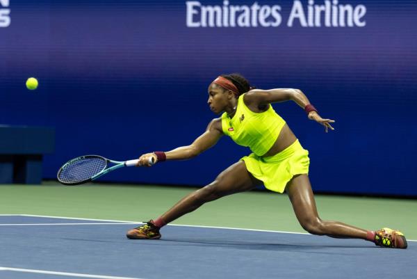 Coco Gauff returns a volley against Carolina Muchova