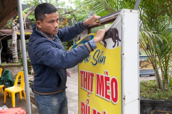 Pham Quoc Doanh tore down the sign advertising cat meat.