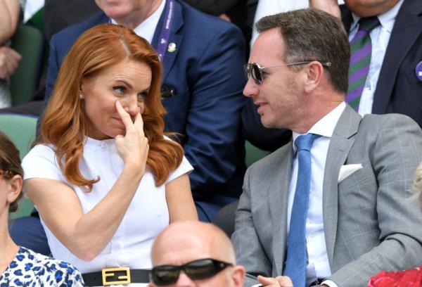 Geri Halliwell, pointing at her eyes while looking at Christian Horner, wearing sunglasses