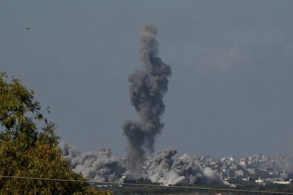 Smoke rises from buildings, viewed from the Israeli side of the border, as the Israeli military co<em></em>nducts a bombardment on October 15, 2023 in northern Gaza
