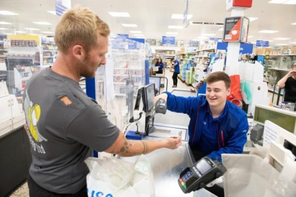 man getting his tesco clubcard scanned on his wrist