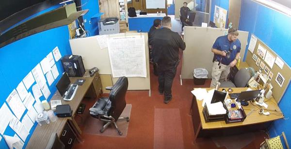 Surveillance video showing police raiding the Marion County Record's newspaper office