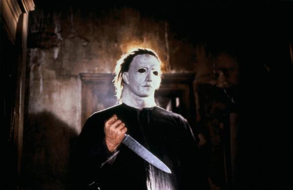 Michael Nyers with a creepy white mask holding a knife in 
