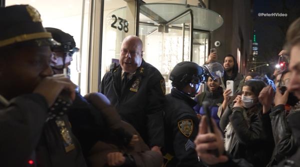 Video shows NYPD Assistant Chief James McCarthy and his officers being chased and surrounded by protestors on Mo<em></em>nday night while trying to get inside the NYU Catholic Center after arresting one of them.