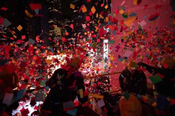 Times Square Alliance volunteers throw co<em></em>nfetti as the clock strikes midnight as seen from the New York Marriott Marquis during the New Year's Eve celebration in Times Square on Jan. 1, 2024, in New York.