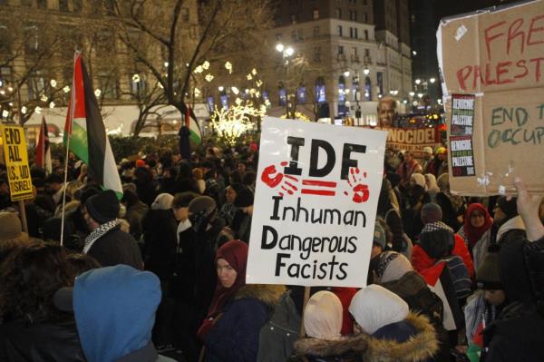 Protesters gather during New Year's Eve in front of Macy's at Herald Square. December 31, 2023.