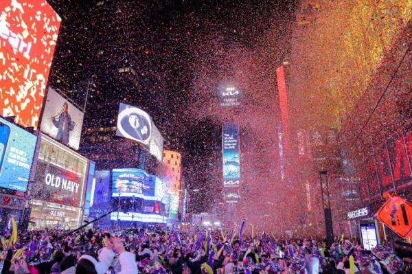 People watch co<em></em>nfetti flying around after the clock strikes midnight during New Year celebrations at Times Square, in New York City, New York, on Jan. 1, 2024.