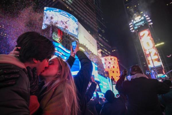 A couple kisses at midnight in Times Square on Jan. 1, 2024 in New York City.